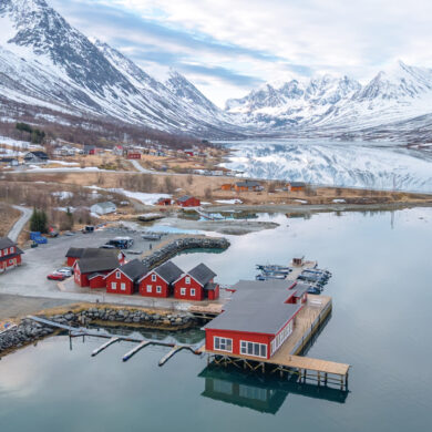 Waterfront cabins in the Lyngen Alps surrounded by dramatic Arctic nature