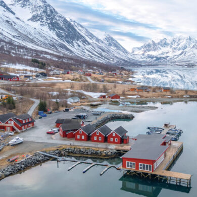 Waterfront cabins in the Lyngen Alps surrounded by dramatic Arctic nature