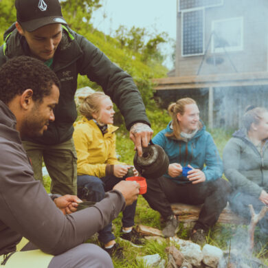 Hikers enjoying a bonfire together in the Lyngen Alps in the Northern Norway