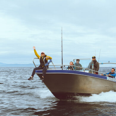 Lyngenfjord boat rental fishing trip in Norway with guests and Arctic mountain views