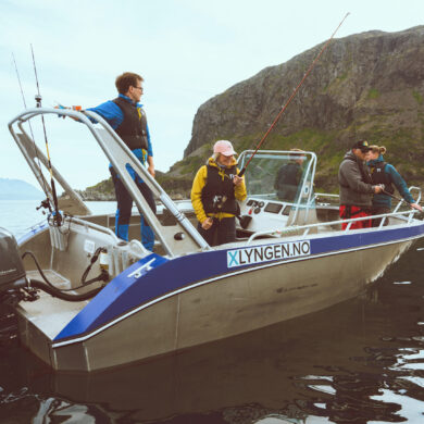 boat rental fishing trip on Lyngenfjord Norway with guests on deck and mountain views